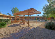 Thumbnail 13 of 16 - a patio with a picnic table and a pergola
