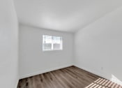 Thumbnail 6 of 14 - the living room of our studio apartment atrium with wood flooring and a window