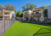 Thumbnail 32 of 32 - the outlook of a yard with a fence and apartment buildings