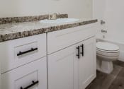 Thumbnail 6 of 12 - a bathroom with a sink and a toilet