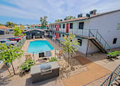 Thumbnail 17 of 20 - A pool surrounded by a fence and a building.