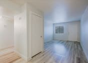 Thumbnail 5 of 12 - a bedroom with hardwood floors and white walls
