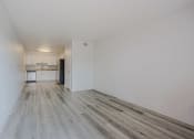 Thumbnail 2 of 12 - a bedroom with hardwood floors and white walls