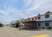 Thumbnail 14 of 14 - a parking lot in front of a building