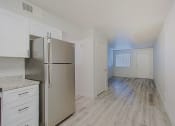 Thumbnail 4 of 12 - a kitchen with white cabinets and a stainless steel refrigerator