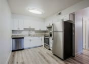 Thumbnail 3 of 12 - a kitchen with white cabinets and stainless steel appliances