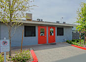 Thumbnail 19 of 20 - A building with a red door and a no parking sign in front.