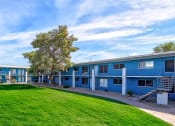 Thumbnail 15 of 24 - the building where the motel is located is painted blue and has a green lawn