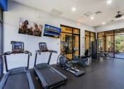 Thumbnail 19 of 23 - the gym has cardio equipment and glass doors to the pool