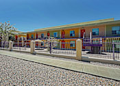 Thumbnail 12 of 16 - A row of colorful buildings with a fence in front.