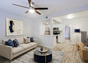 Thumbnail 1 of 23 - A living room with a beige couch and a painting on the wall.