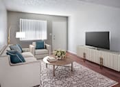 Thumbnail 1 of 19 - A living room with a white couch, a coffee table, and a flat screen TV at Gilbert Square Apartments, Mesa, AZ 85203