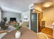 Thumbnail 2 of 19 - A living room with a grey couch and a wooden coffee table at Gilbert Square Apartments, Mesa, AZ 85203