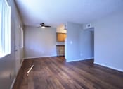 Thumbnail 9 of 19 - A room with wooden floors and a ceiling fan at Gilbert Square Apartments, Mesa