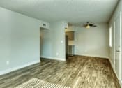 Thumbnail 13 of 19 - A living room with a ceiling fan at Gilbert Square Apartments, Mesa, AZ 85203