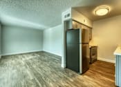 Thumbnail 12 of 19 - A kitchen area with a refrigerator and oven at Gilbert Square Apartments, Mesa