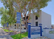 Thumbnail 19 of 19 - a large white building with a blue sign in front of it