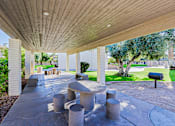 Thumbnail 21 of 25 - A concrete patio with a wooden roof and a mailbox.