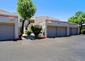 Thumbnail 83 of 94 - A tree is in front of a building with three garage doors.