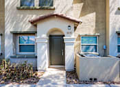 Thumbnail 29 of 29 - A house with a brown door and windows with white frames.
