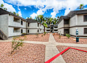 Thumbnail 26 of 26 - A courtyard with a red line in the middle and a building on the right.