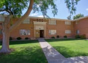 Thumbnail 5 of 21 - a large brick building with a lawn in front of it