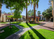 Thumbnail 25 of 32 - a courtyard with trees and buildings with grass and sidewalks