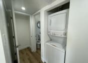 Thumbnail 3 of 6 - a small bathroom with a washer and dryer in a closet