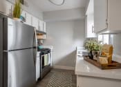 Thumbnail 2 of 24 - a kitchen with stainless steel appliances and white cabinets