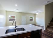 Thumbnail 4 of 29 - A kitchen with a sink and a window.