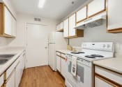 Thumbnail 2 of 15 - a kitchen with white appliances and wooden cabinets