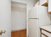 Thumbnail 3 of 15 - a kitchen with white cabinets and a white refrigerator
