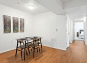 Thumbnail 4 of 15 - a dining room with a table and chairs