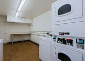 Thumbnail 16 of 16 - A laundry room with a washer and dryer.