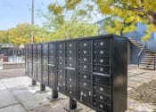 Thumbnail 7 of 10 - a group of mailboxes sitting on a sidewalk