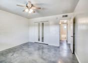 Thumbnail 10 of 10 - a bedroom with white walls and a ceiling fan