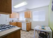 Thumbnail 17 of 21 - a kitchen with wooden cabinets and a white table