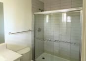 Thumbnail 7 of 8 - a small bathroom with a toilet and a shower