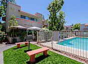 Thumbnail 63 of 94 - A pool surrounded by a fence and a bench.