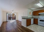Thumbnail 5 of 21 - A kitchen with white appliances and wooden cabinets.