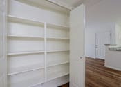 Thumbnail 8 of 21 - A white pantry with shelves and a door.