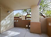 Thumbnail 13 of 21 - A sunny day at a courtyard with a brown door.