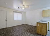 Thumbnail 3 of 15 - A room with a white ceiling fan and a window with blinds.