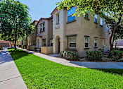 Thumbnail 22 of 29 - A row of houses with green lawns in front.