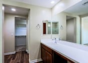 Thumbnail 17 of 29 - A bathroom with a white counter top and a mirror above it.