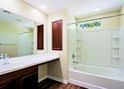Thumbnail 8 of 29 - A bathroom with a white tub and sink.