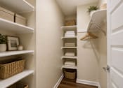 Thumbnail 12 of 29 - A hallway with a white door and a rack of towels.