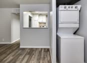 Thumbnail 6 of 9 - an empty apartment with a washer and dryer and a kitchen
