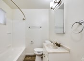 Thumbnail 7 of 9 - a bathroom with a shower toilet and sink and a mirror