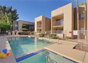 Thumbnail 10 of 15 - a swimming pool with a beach ball in front of a building